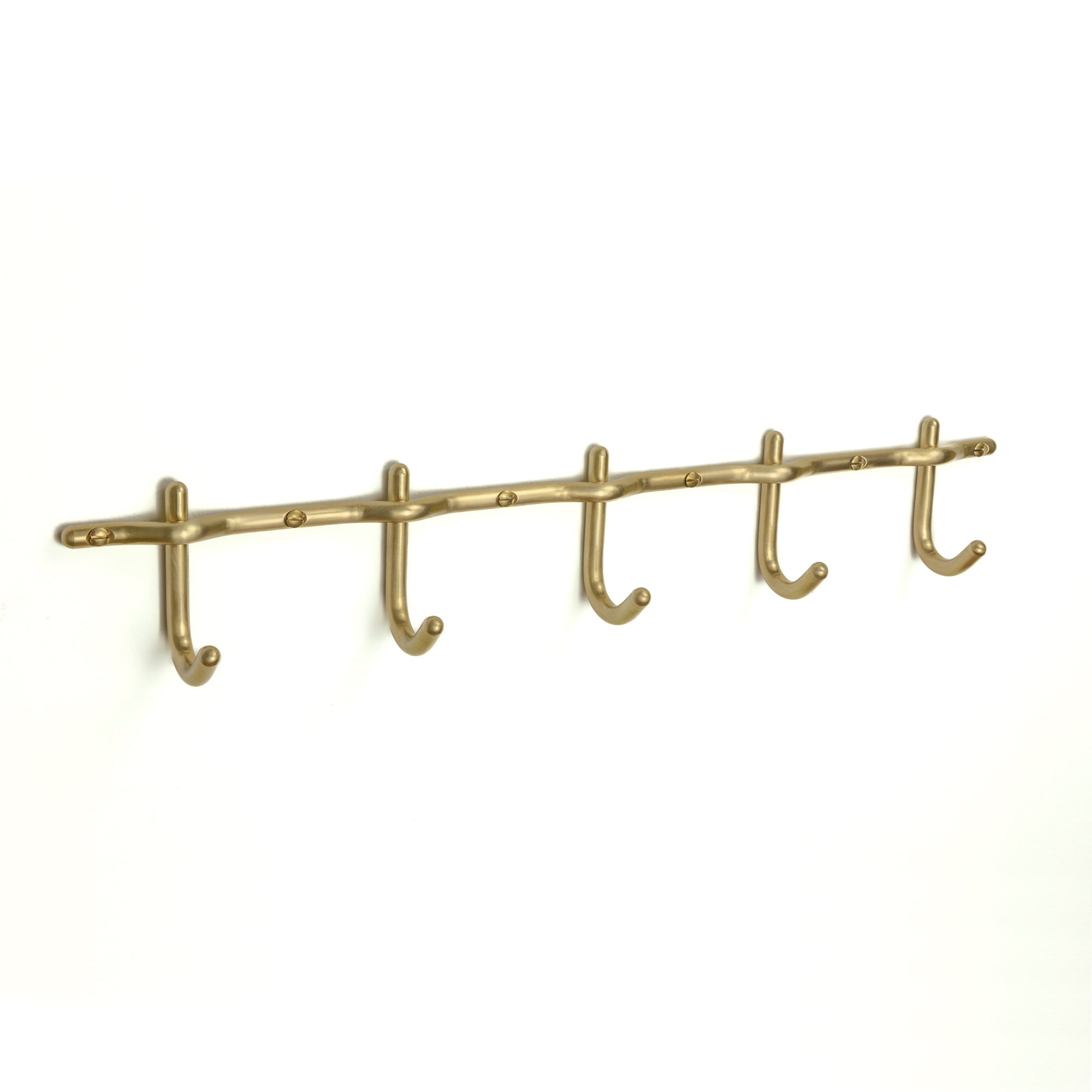 Hand-finished unlacquered brass hook rail, made in Vancouver.