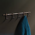 Hand-finished unlacquered brass hook rail, made in Vancouver