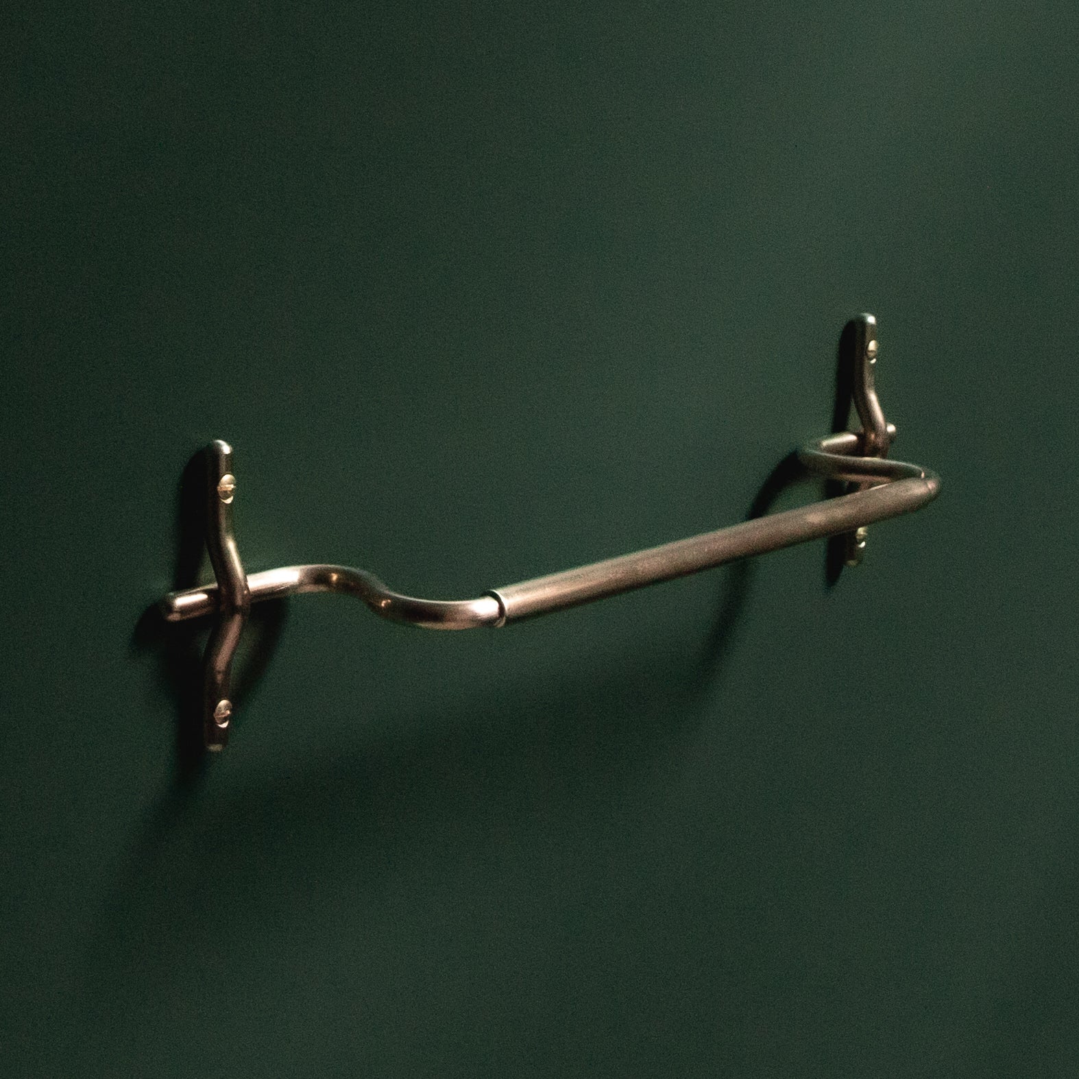 Hand-finished unlacquered brass hand towel bar, made in Vancouver