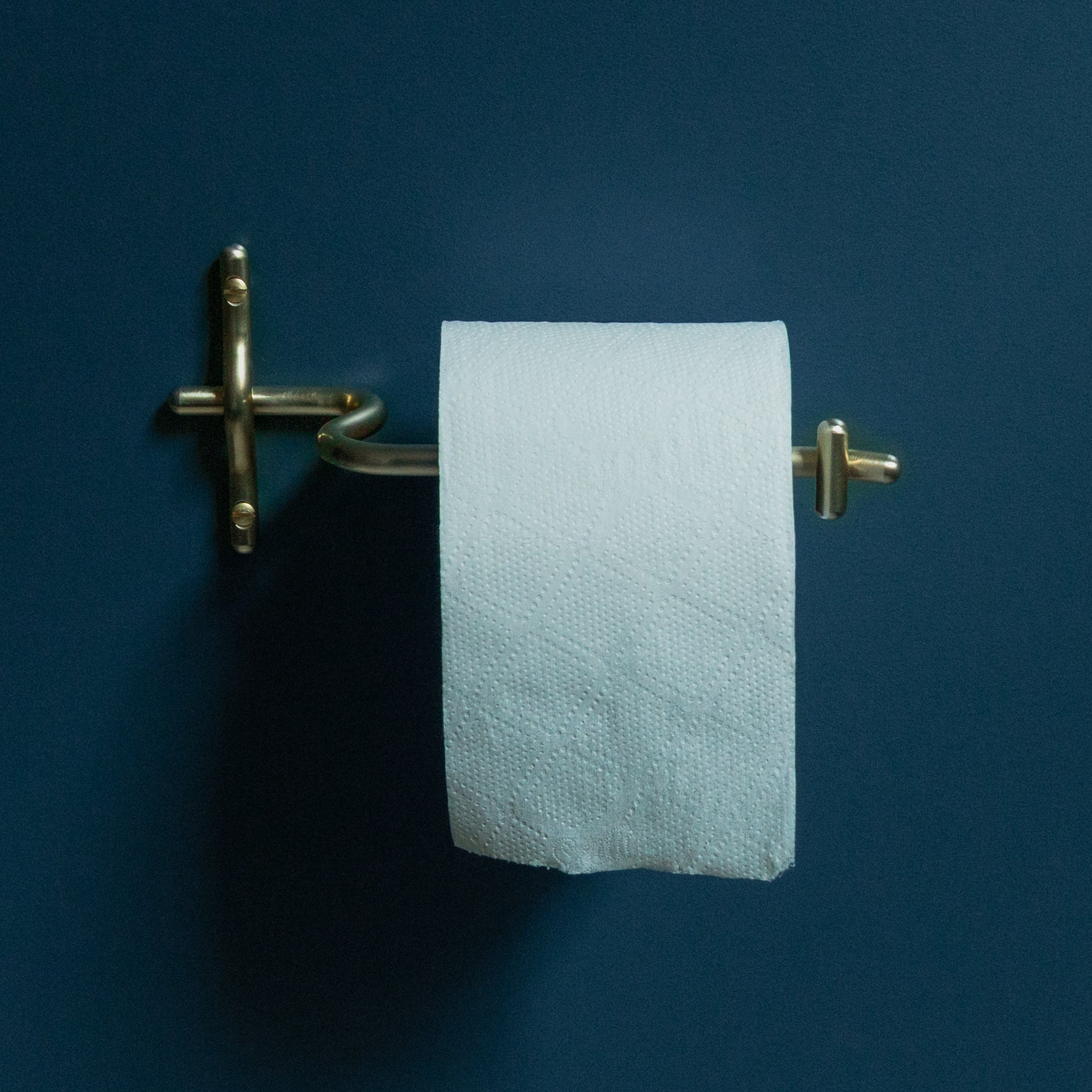 Hand-finished unlacquered brass toilet roll holder, made in Vancouver